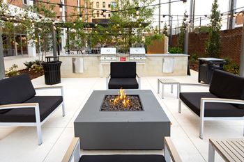 An outdoor patio with a fire pit and barbecue